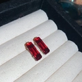 Detailed view of red rectangular zircon earrings set on a white jewelry display cushion - Large / Red