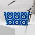 Close-up of waterproof makeup bag featuring blue evil eye patterns and white polka dots - Blue Pupil White Dots