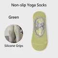 Light green non-slip yoga socks with elastic straps and white silicone grip details - Green