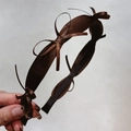 Close-up of elegant dark brown satin headband with chic bow detailing and silky finish - Brown
