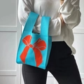 Bright blue knitted handbag with contrasting orange bow pattern for daily fashion - Sky Blue Bow