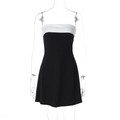 Detailed close-up of a bodycon mini dress with black and white color block design - S / Black
