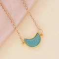 Minimalist gold necklace with blue crescent moon pendant on silk fabric background - Lake Blue