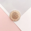 Macro shot of gold-plated alloy charm with pearls and rhinestones for DIY decoration - Gold Round Champagne