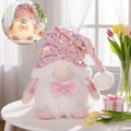Pink and white glowing gnome plush with sequins and a glittery bow decoration - Male Glowing Gnome Ornament