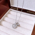 Detailed view of silver starburst pendant with zircon on a wooden jewelry box liner - Silver