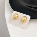 Macro detail of minimalist gold-finish bean earrings on white presentation card - 37# Gold Bean Mirror Polished Studs (37# Silver Earring Post-Gold-Real Gold Plated)