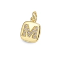 Close-up of a square gold pendant featuring letter M and sparkling zircon stones - Letter M