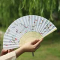 Traditional Chinese folding fan with hand-painted floral patterns and bamboo ribs with tassels - Flower Bird Skirt Pattern