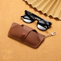 Brown lychee texture leather glasses pouch with metal chain and black sunglasses - Brown