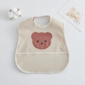 Waterproof baby feeding bib in beige featuring a cute brown bear pattern with pocket - Pu Bib (double-layered) - With A Beige Edging And A Small Bear Head / One Size