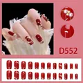 Detail view of red D552 press-on nails with gold lines, pearls, and French tips - Dark Red Gold Thread Pearl (D552) / 24 Pcs/Set