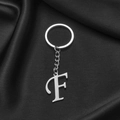 Silver stainless steel keychain featuring a polished capital letter F pendant on black silk - Letter F