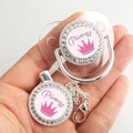 Detail of silver baby pacifier with pink crown pattern and Princess text with clip - Silver Princess (Transparent Shield)