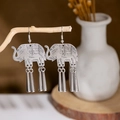 Detailed shot of vintage silver elephant earrings with metal tassels on a wooden branch - E2874-21/Elephant Tassel