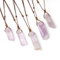 Five irregular purple amethyst pendants on brown woven cords displayed on white background - Light Amethyst