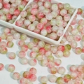 Macro shot of 10mm pink and green glass beads for DIY jewelry making and bracelets - Huaxi (10mm Protein Jade)