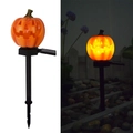Solar powered orange pumpkin garden stake light showing day and night glowing effect - Plastic Pumpkin