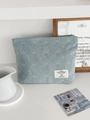 Pochette trucchi in denim azzurro con motivo a fiocchi bianchi e cerniera - Azzurro