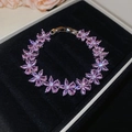 Macro detail of a pink zircon flower bracelet inside a premium black velvet jewelry box - Bracelet-Pink