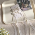 Handmade white lace and ribbon tulip hair clip set on display card with floral background - White Lace Hair Clip