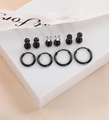 Black geometric earring set of 10 including studs and hoops on white display blocks - Black
