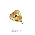 Macro view of gold heart charm connector with zircon evil eye and radial texture - Heart Evil Eye Connector