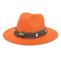 Detail of orange straw hat featuring an ethnic band with turquoise beads and tassels - Orange