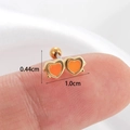 Vista detallada de pendientes de doble corazón naranja y oro con medidas sobre un dedo - Dorado-Corazón Naranja