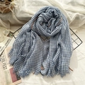 Blue and white plaid wool scarf with tassel edges on a minimalist wire display - Haze Blue Grid