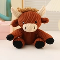 Handmade crochet amigurumi brown cow plush toy with cute horns in cozy home setting - 16cm Calf