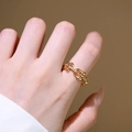 U-shaped gold ring with horseshoe buckle and zircon pavé worn by a model in warm light - U-Shaped Horseshoe Buckle / Gold