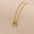 Detailed view of golden letter A pendant with sparkling zircons on O-chain necklace - Letter A