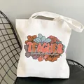White canvas tote bag featuring vintage flowers and 'TEACHER blessed' printed design - Style C12