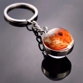 Mars planet keychain with double-sided glass ball and metal ring on black background - Mars