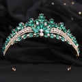Macro detail of royal tiara featuring emerald green rhinestones and golden alloy frame - KC Gold Green Rhinestone