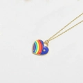 Close-up of a rainbow and blue enamel heart pendant with a small rhinestone on a gold chain - Sapphire Blue