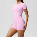 Close-up of pink athletic yoga set showing high-waisted shorts and short sleeve top - S / Top And Bottom / Sakura Pink