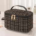Elegant black and gold tweed makeup bag with classic quilted texture and leather handle - Black