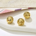 Macro shot of 8-9mm hollow golden ball beads with circular peace sign pattern for DIY jewelry - Style 5