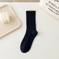 Chic black rib-knit crew socks with cream lettuce edge trim and minimalist aesthetic - One Size / Black