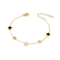 Gold star charm bracelet with black enamel and white mother of pearl details on white background - Pentagram
