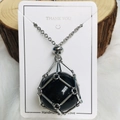 Silver mesh cage necklace with black crystal sphere pendant on white gift card - Silver Obsidian