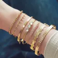 7-piece bohemian gold alloy bracelet set featuring beaded chains and crystal accents - 7-Piece Set / Gold