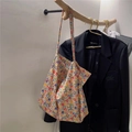 Floral cotton tote bag with vintage print hanging on wooden hanger over a blazer - Red Orange Blue Small Flower