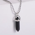 Detailed view of a hexagonal black onyx bullet pendant on a silver beaded chain - Black Agate Style