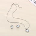 Detailed view of silver heart pendant and earrings set with white shell inlay - 2-Piece Set (Necklace+Earrings) / Silver