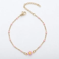 18K gold daisy bracelet with pink beads and yellow enamel center on a fine chain - Gold + Pink