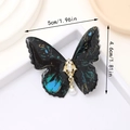 Fermaglio a farfalla marmorizzata verde acqua con perla e strass, 5 cm x 4,6 cm - Nero