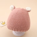 Close-up of pink knitted baby hat featuring cute white 3D ears and ribbed texture detail - 5-20 Months / Pink